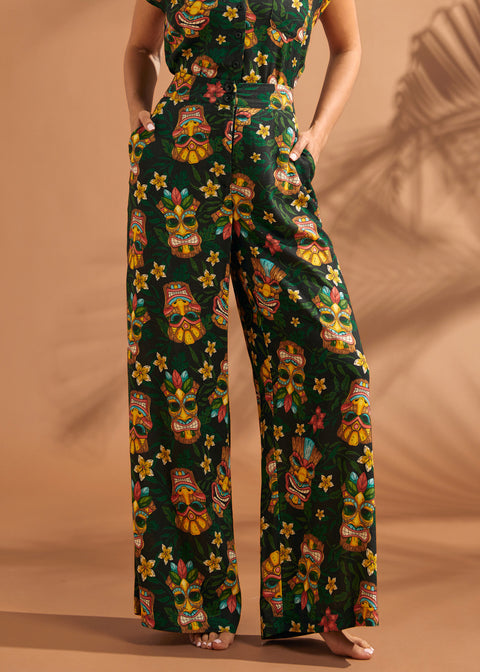 Full-length view of black tropical floral and tiki print pants with high-rise waist.