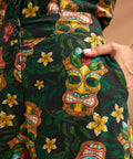 Detail of functional side pocket on tropical novelty print wide leg trousers.
