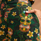 Detail of functional side pocket on tropical novelty print wide leg trousers.
