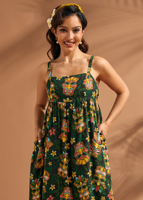Front view of tiki print linen blend maxi dress with side pockets.
