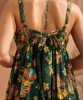 Close-up of adjustable straps and oversized tie back on tropical maxi dress.