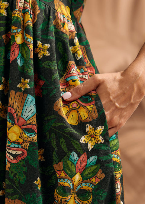 Close-up of functional side pocket on tropical tiki print maxi dress.