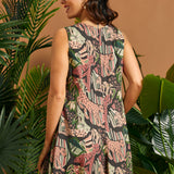 Back view of the sleeveless jungle print A-line dress with clean lines and mini length.
