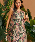 Woman posing in a sleeveless tropical print mini dress with relaxed A-line silhouette.