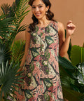 Woman smiling while wearing a vintage-inspired jungle print mini dress with botanical motif.