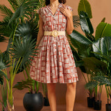 Front view of vintage-inspired cap sleeve button front dress with woven belt.