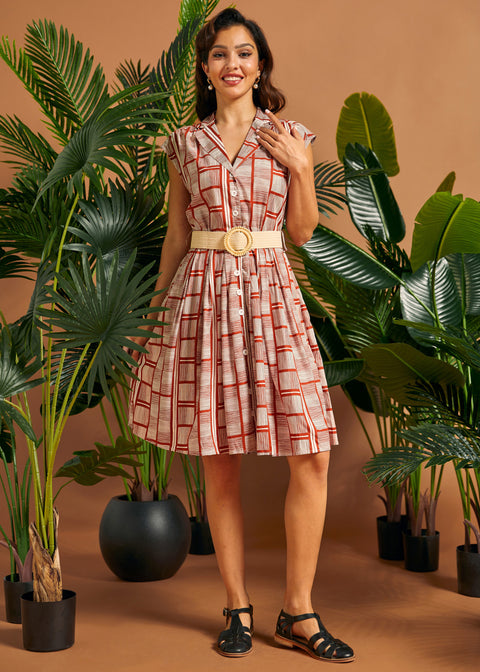 Front view of vintage-inspired cap sleeve button front dress with woven belt.