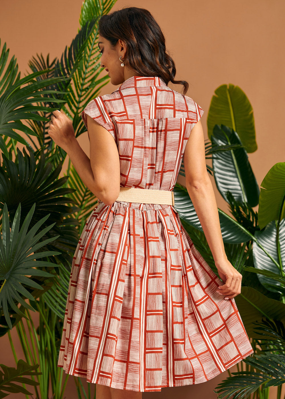 Back view of cap sleeve shirt dress with gathered skirt.