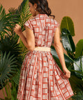 Back view of cap sleeve shirt dress with gathered skirt.
