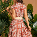 Back view of cap sleeve shirt dress with gathered skirt.