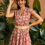 Woman wearing vintage-inspired fit-and-flare dress with removable woven belt.