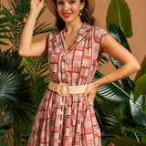 Woman wearing vintage-inspired fit-and-flare dress with removable woven belt.
