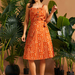 Vintage-inspired A-line wrap skirt with self-tie belt and botanical print.