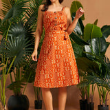 Vintage-inspired A-line wrap skirt with self-tie belt and botanical print.