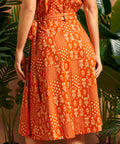 Back view showing wrap overlap and self-tie belt on midi skirt.