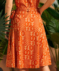 Back view of orange wrap skirt with side tie detail.