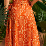 Back view of orange wrap skirt with side tie detail.