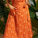 Close-up of functional patch pocket on orange cotton A-line skirt.