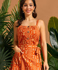 Woman wearing a cropped cotton camisole with gathered neckline and oversized buttons.
