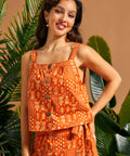 Front view of retro orange square neck cami paired with a coordinating wrap skirt.