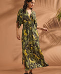Woman wearing a flowing vintage-inspired jungle print maxi dress with side slit and flutter sleeves.