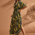 Three-quarter view of a woman wearing a vintage-inspired flutter sleeve maxi dress in a jungle print.