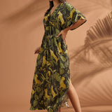 Three-quarter view of a woman wearing a vintage-inspired flutter sleeve maxi dress in a jungle print.