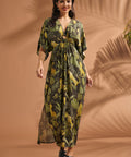 Woman walking in a lightweight jungle print maxi dress with dramatic flutter sleeves and side pockets.