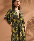 Woman wearing a tropical jungle print maxi dress with flutter sleeves and ring front keyhole detail.