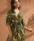Front view of a woman wearing a relaxed-fit maxi dress with flutter sleeves and novelty jungle print.