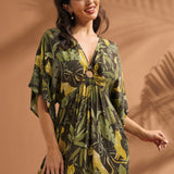 Front view of a woman wearing a relaxed-fit maxi dress with flutter sleeves and novelty jungle print.
