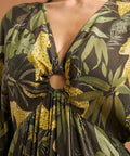 Close-up of the V-neckline with gathered ring detail and keyhole opening on a tropical print maxi dress.