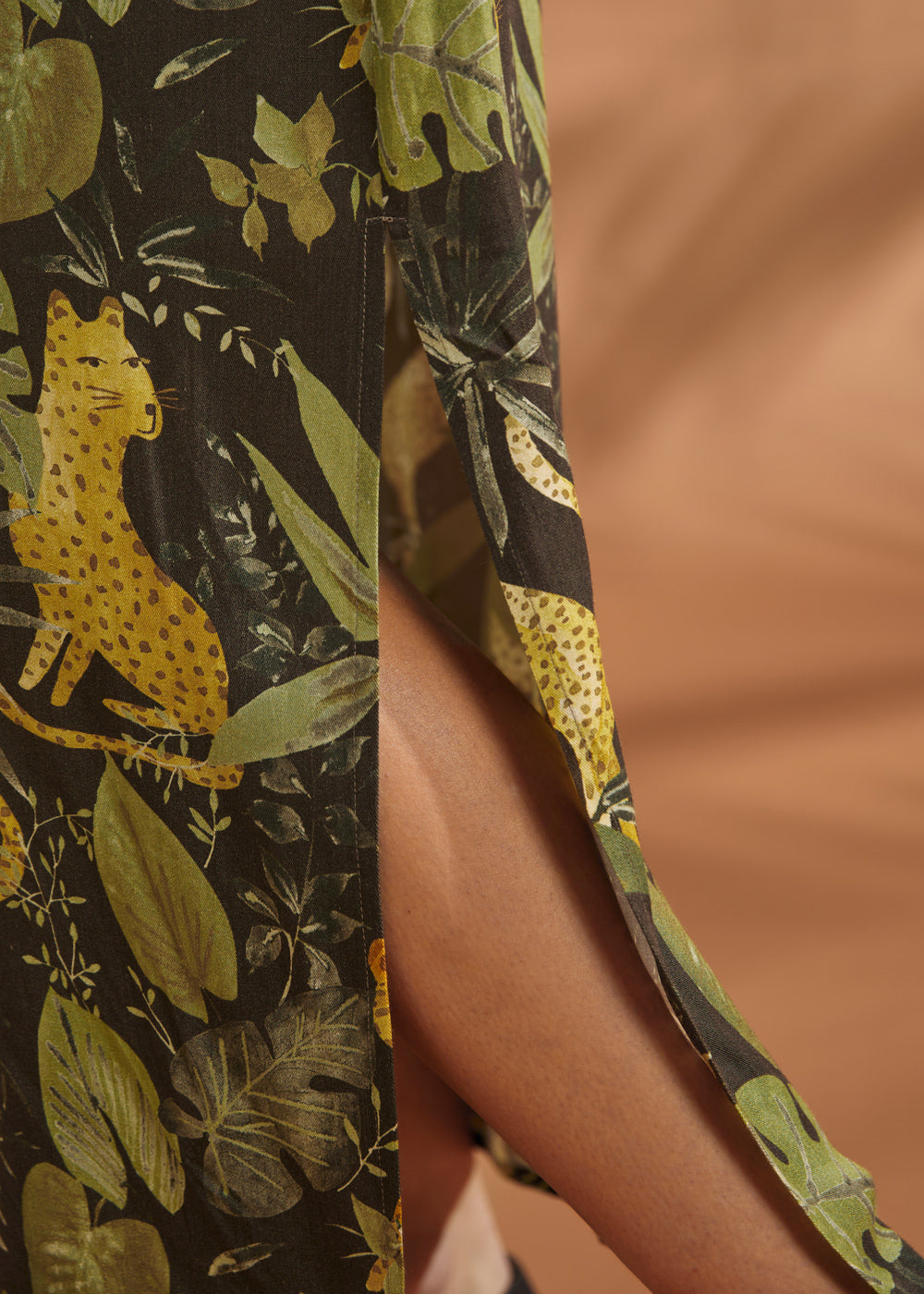 Close-up of the side slit on a lightweight tropical print maxi dress.