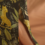 Close-up of the side slit on a lightweight tropical print maxi dress.