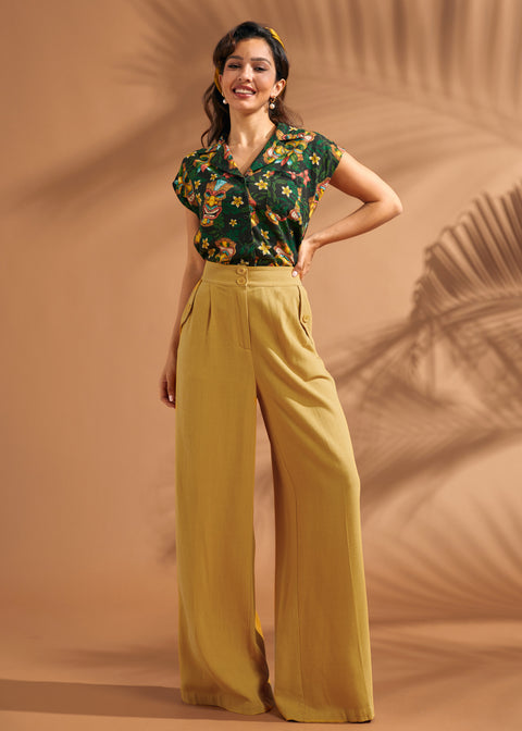 Front view of mustard high waisted pants with pleated wide leg silhouette.
