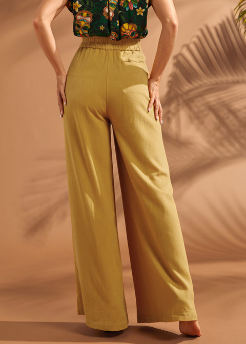 Back view of mustard wide leg pants with elastic waistband and welt pocket.