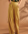 Detailed view of high waist and decorative button accents on vintage-inspired wide leg pants.