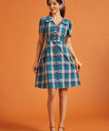 Full-length view of blue plaid A-line shirt dress with pockets and oversized collar