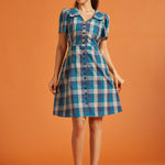 Full-length view of blue plaid A-line shirt dress with pockets and oversized collar