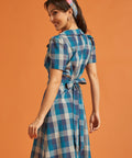 Side view of vintage-inspired blue plaid dress with button-front design and flared skirt