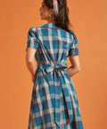 Back view of blue plaid cotton shirt dress with self-tie waist sash