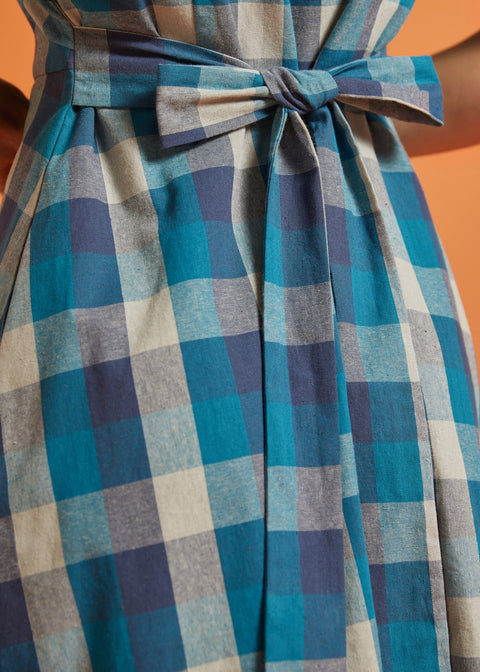 Close-up of back tie belt on blue plaid fit-and-flare dress