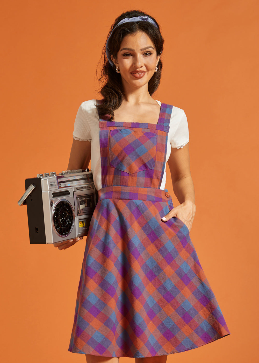 Front view of fit-and-flare plaid jumper dress with pockets