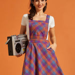 Front view of fit-and-flare plaid jumper dress with pockets