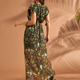 Back view of tropical maxi dress with tassel sleeve ties and flowing silhouette.