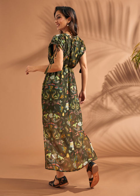 Back view of tropical maxi dress with tassel sleeve ties and flowing silhouette.