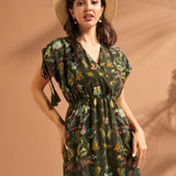 Close-up of faux wrap neckline and whimsical underwater print on green maxi dress.
