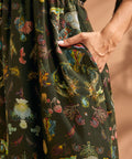 Close-up of side pocket on tropical novelty print maxi dress.