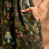 Close-up of side pocket on tropical novelty print maxi dress.