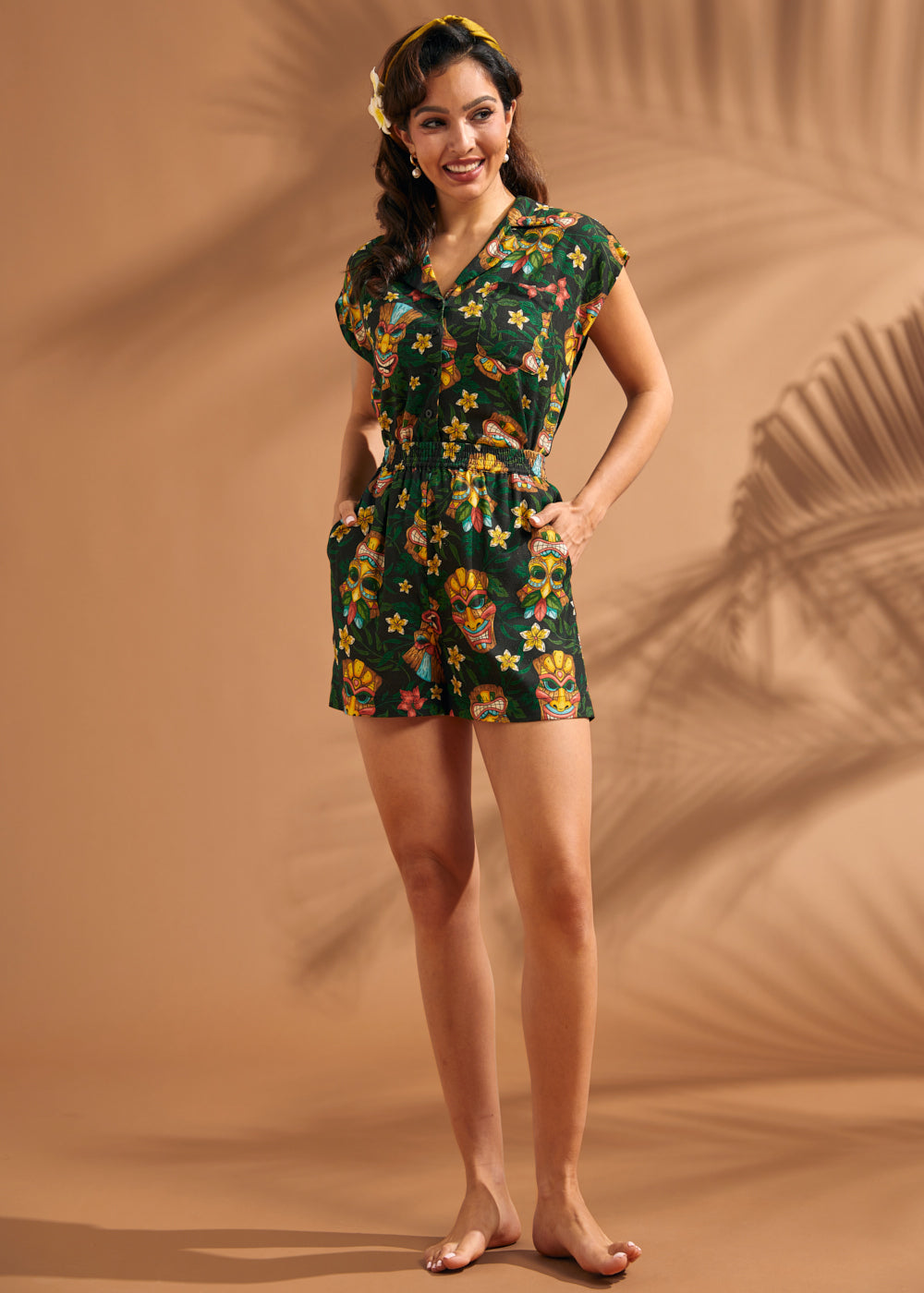 Woman wearing matching tiki print blouse and relaxed pull-on shorts set.